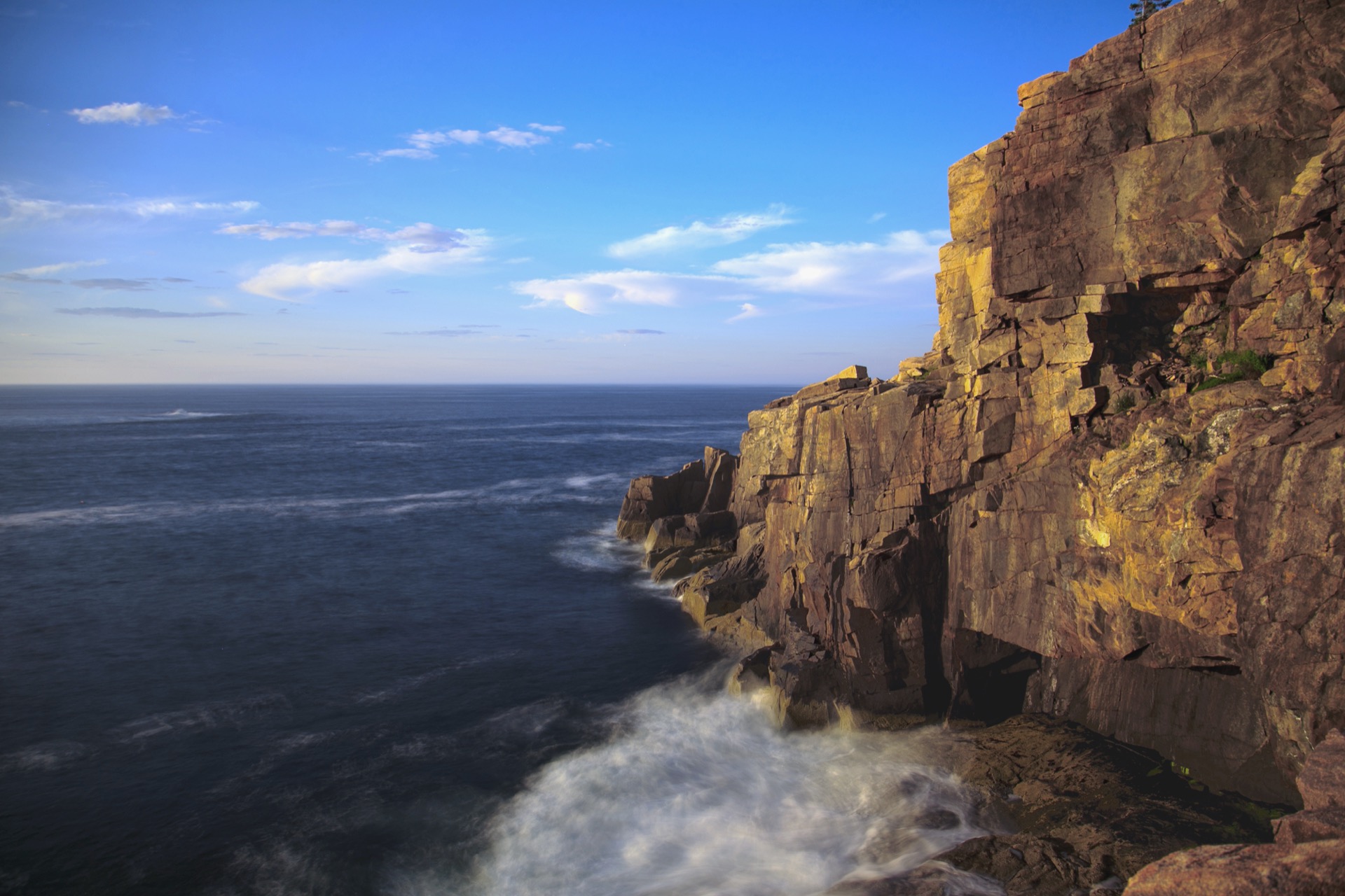 Golden light on the granite face of Otter Cliffs meeting the Atlantic, Acadia National Park