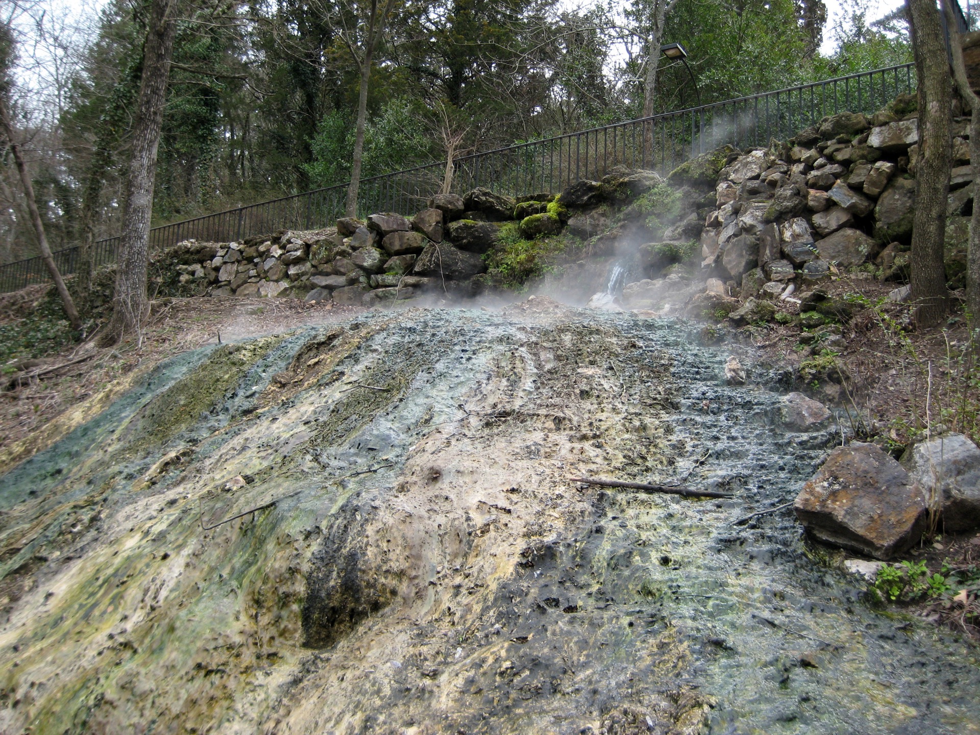 Mineral-stained thermal spring water flowing and steaming at Hot Springs National Park
