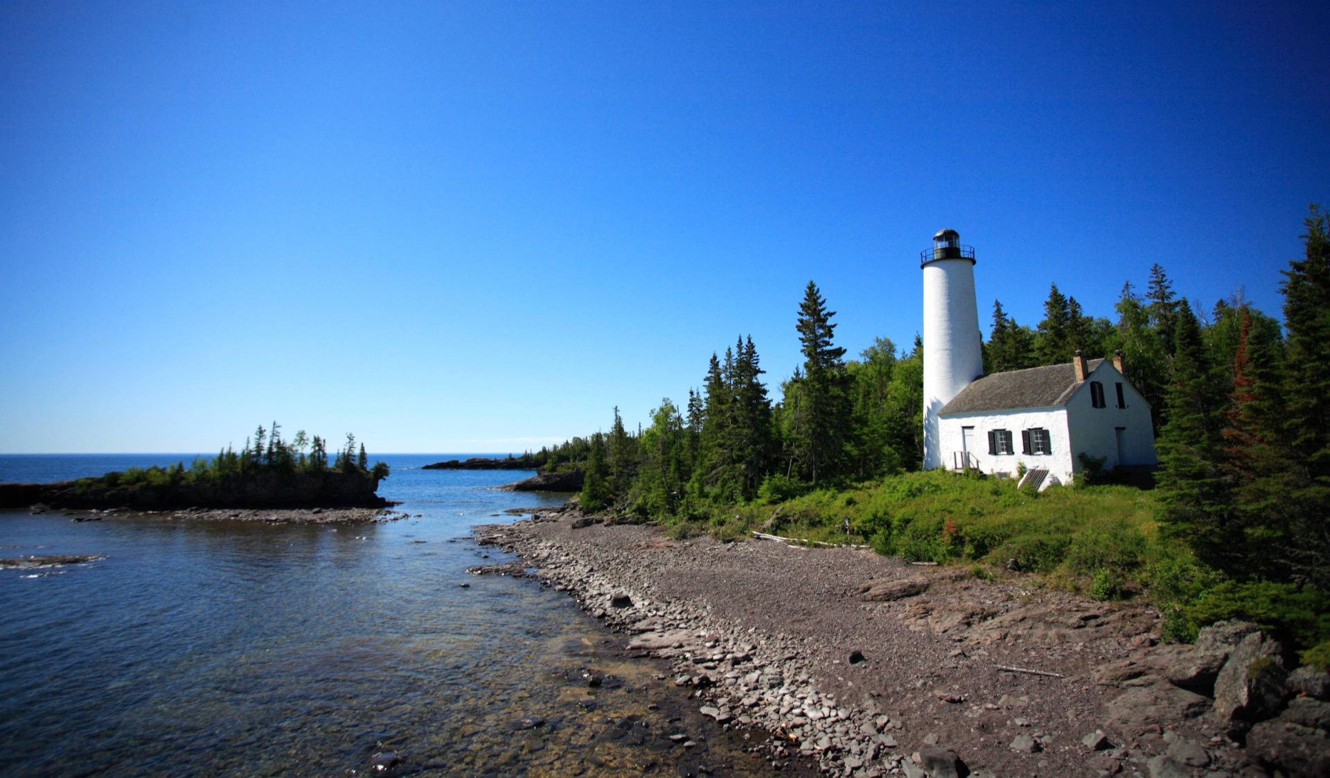 Rock Harbor Lighthouse on a rocky point at Isle Royale National Park
