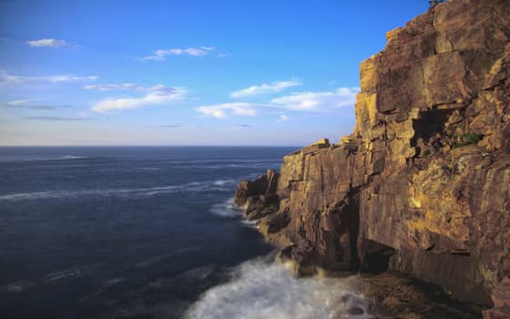 Golden light on the granite face of Otter Cliffs meeting the Atlantic, Acadia National Park