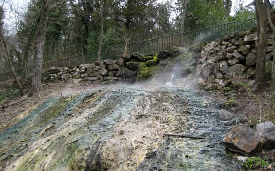 Mineral-stained thermal spring water flowing and steaming at Hot Springs National Park