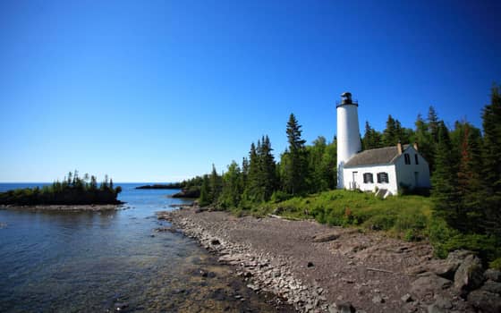 Rock Harbor Lighthouse on a rocky point at Isle Royale National Park